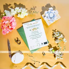 A clean and elegant flat-lay of a building-themed inauguration card. The design uses a simple color palette and high quality paper stock to create a professional and stylish announcement for a grand opening ceremony.