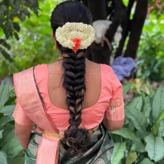Another view of the traditional floral braid, showing how securely it is constructed to last through a long day of ceremonies and celebrations.