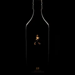 A wider view of the minimalist Johnnie Walker concept. Here, you see the full silhouette of the bottle, defined by a thin, golden line of light. It's a testament to how much can be said with very little, focusing on shape and brand identity.