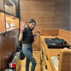 A full-length shot of me at the console at Mayouchi, giving a peace sign. Just a happy, casual moment before a gig.