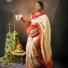 This portrait shows the mom-to-be holding a traditional puja thali, symbolizing blessings for the new life. The bare baby bump is a beautiful and modern touch to the traditional concept.
