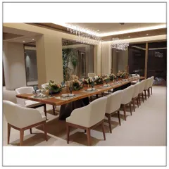 A dining area designed for memorable gatherings. The custom-made wooden table, surrounded by comfortable upholstered chairs and illuminated by a stunning crystal chandelier, sets the stage for elegant dinners and celebrations.