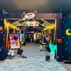 An amazing custom entrance for a space-themed birthday party. I created a tunnel effect with personalized banners and lighting to welcome guests to Liyansh's first trip around the sun.