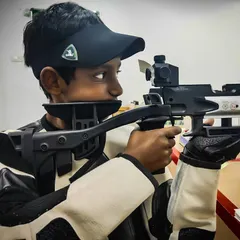 A close-up of a young shooter demonstrating intense focus while aiming his Hammerli air rifle. I teach techniques that build discipline and concentration.