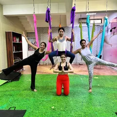We fly higher together. My classes are built on a foundation of community and mutual support, where we celebrate each other's progress and share in the joy of movement. This group pose shows the fun and connection we build.