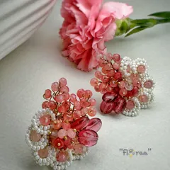 A rosy look for rosy styling. These red and pink earrings are designed with rose quartz and edged with white glass beads.