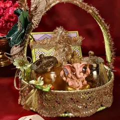 This is one of my favourite creations for Ganesh Chaturthi. This ornate basket is filled with traditional treats, including a hand-painted Ganesha idol, making it a complete and auspicious offering for the festival.