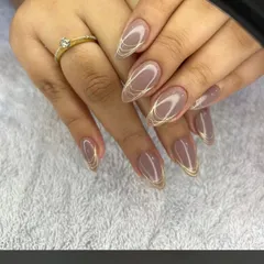 A sophisticated almond-shaped set in a mauve-nude color, with delicate gold thread-like lines wrapping around each nail.