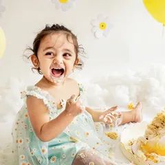 This is the pure, unfiltered joy of a first birthday! This little pataka had the best time with her daisy-themed cake smash. My goal is to capture your child's personality, and this picture of her laughing with a face full of cake says it all.