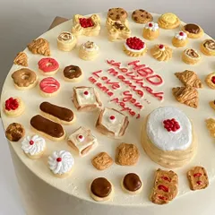 A cake for the ultimate foodie, decorated with dozens of miniature edible pastries, from croissants and donuts to eclairs.