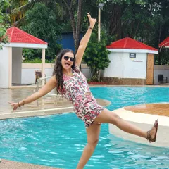 Having a blast by the pool. This energetic and playful pose in a floral co-ord set is ideal for vacation wear or lifestyle brand advertising.