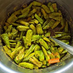 Here is a batch of stuffed green chillies being prepared. Once stuffed, they are mixed together to ensure the masala is evenly distributed before being packed into jars to mature.