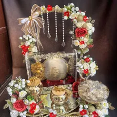 The first wedding invitation sets the tone for the entire celebration. I designed this royal 'first card' platter to be a grand statement, combining traditional elements with elegant red and gold floral arrangements to give the families a truly special moment.