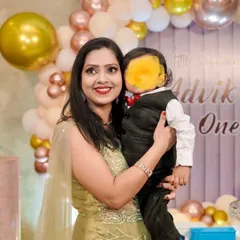 The beautiful client from the testimonial, celebrating her son's birthday. Her makeup features a classic winged liner and a bright red lip, looking fresh and radiant for the party.