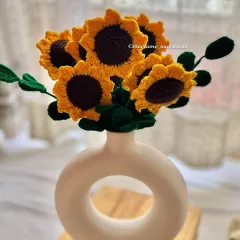 A lovely bunch of my crochet sunflowers arranged in a modern white donut vase. This shows how beautifully these forever flowers can brighten up your home decor.