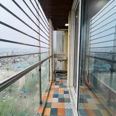 A lovely balcony with a city view, featuring colorful and patterned patchwork floor tiles. This adds a vibrant and artistic touch to the outdoor space.