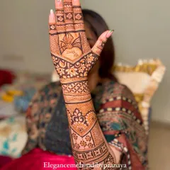 A lovely backhand design with a heart and the groom's name 'Zuber' hidden in the center, held up by a happy bride.