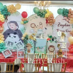 Zaydan's first birthday was a cute and colorful jungle party. The decor features adorable cartoon animal cutouts, a personalized backdrop, and a multi-colored balloon garland, perfect for a cheerful and bright celebration.