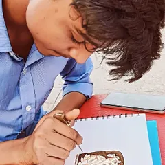 Practice makes perfect. Here, one of my artists is sketching a new design on paper with a henna cone. We are always working on new patterns and perfecting our skills to bring you the best work.