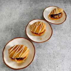 Soft golden buns filled with rich layers of flavor and topped with a delicate drizzle. These little beauties are proof that happiness really does come in small plates.