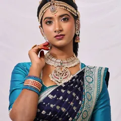 A close-up portrait that captures the essence of the look. The makeup is flawless, the jewelry is exquisite, and the expression is one of quiet confidence and grace.