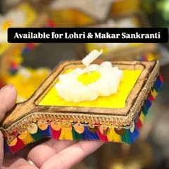 For Lohri and Makar Sankranti, I create these special kite-shaped wooden trays with a central candle, decorated with colorful tassels.