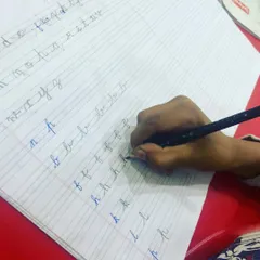 Back to basics with letter drills. This image shows a student practicing the formation of individual cursive letters, a crucial exercise for building a strong foundation in penmanship.