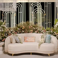 A chic lounge area with a backdrop of white wire mesh arches, softened by a lush base of pastel florals. This is how I blend modern industrial materials with romantic wedding decor.