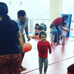 This image captures the pure excitement of a birthday party. A child runs with a bright smile, fully immersed in the fun and games of the day.