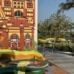 A detail of the functional art bench, where the mosaic forms an undulating, sculptural seating area that is both a piece of art and a place for community.