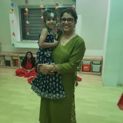 A proud instructor holds one of our little dancers during a festive celebration. We encourage our team to build strong, nurturing bonds with the children, creating a true sense of family and community at the club.