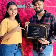 Another shot of Ritik, proudly pointing to his hard-earned certificate. He put in the work during his hands-on training and is now a certified nail artist.