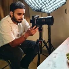 A behind-the-scenes look at our photographer setting up a shot. We use professional lighting and camera equipment to achieve high-quality results.