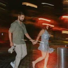 A pre-wedding story from the UAE desert. This motion-blur shot of the couple running barefoot at night captures the energy and magic of a shoot in Dubai.