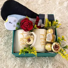 A perfect gift to celebrate a new chapter. This engagement hamper for a couple includes a matching set of "His" and "Hers" mugs, delicious Ferrero Rocher chocolates, and a cute penguin eye mask, all elegantly arranged to congratulate the happy pair.