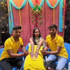 My artists with a client at her mehndi function. You can see the beautiful, intricate design covering her hands and arms, ready for her big day.