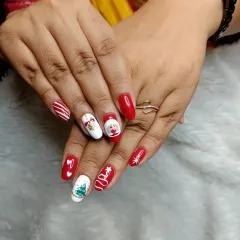 Getting into the festive spirit with this custom Christmas-themed nail art. Each nail features a different hand-painted design, including Santa, a Christmas tree, and candy cane stripes.