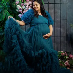 For all the moms-to-be, we have a special collection of maternity photoshoot gowns. This beautiful client is wearing our flowy teal tulle gown, designed for both comfort and style to capture this precious time in your life.