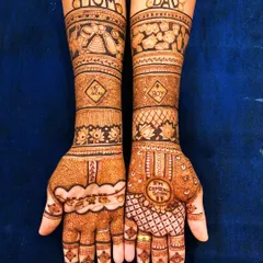 A full bridal-style mehendi for a modern mommy-to-be. This design incorporates 'Mom' and 'Dad' on the arms, along with cute baby elements, celebrating the parents-to-be.