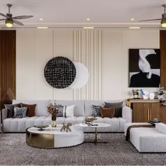 This living room design incorporates rich wood paneling and modern art to create a sophisticated focal point. The combination of a round marble and metal coffee table with plush seating balances bold design with everyday comfort.