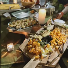 Creating the right vibe is essential. Here, a beautifully arranged cheese board is illuminated by candlelight, demonstrating how I use lighting and decor to craft a specific mood and enhance the overall guest experience.