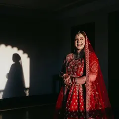 Using light and shadow to create a dramatic and artistic bridal portrait. The silhouette in the background adds a layer of depth and storytelling to the image.