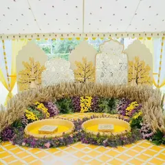 A beautiful Haldi or Mehendi ceremony setup. We used fragrant pampas grass, yellow florals, and intricate cutout backdrops to create a sunny and joyful space for pre-wedding rituals.
