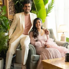 A relaxed portrait of the couple enjoying their cocktail party in a chic, modern venue.