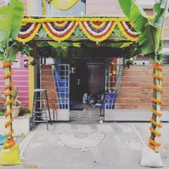 For a traditional housewarming, or Gruhapravesam, we create an authentic and auspicious entrance. This setup features a pandal made with coconut leaves, fresh banana plants, and marigold flower garlands for a truly blessed welcome.