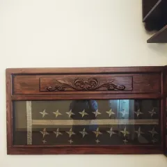 A close-up of the magnificent headboard in the guest bedroom, where a precious wedding sari is sandwiched between ply and glass. The intricate carving on the wood adds to the heritage feel of this deeply personal piece.