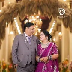 A heartwarming shot of the anniversary couple sharing a loving gaze, their years of togetherness reflected in their smiles.