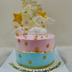 A dreamy "Twinkle Twinkle Little Star" themed baby shower cake. This pink and blue cake features a sleeping moon, fondant stars, and a sweet message for the baby.
