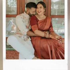 A laughing couple captured in a candid moment, framed like a nostalgic polaroid photo. We love capturing the pure, unposed joy of your celebration.