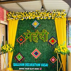 Our Mehndi setups are vibrant and festive. This design features a lush grass wall with a custom "Mehndi" sign and traditional hangings for a beautiful, textured look.